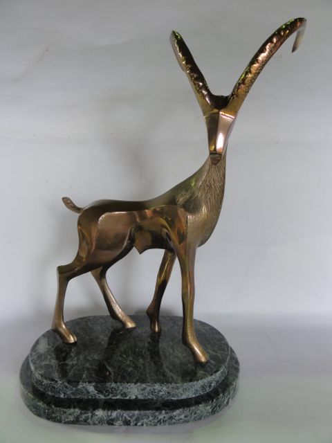 A bronze sculpture by John Mulvey - Alpine Ibex, raised on a stepped flecked marble base, stamped