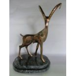 A bronze sculpture by John Mulvey - Alpine Ibex, raised on a stepped flecked marble base, stamped