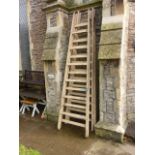 A pair of substantial painted pine A framed folding trestles, 11 1/2 feet high approximately