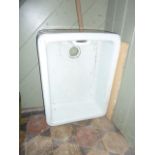 A white glazed ceramic butlers sink