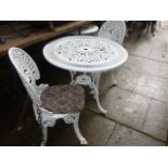 A Victorian style cast aluminium terrace table of circular form with decorative pierced top raised