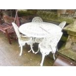 A Victorian style cast aluminium garden terrace table of circular form with decorative pierced top