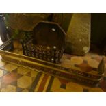 A cast iron fire basket with trellis frieze and combined back with fleur-de-lys detail together with