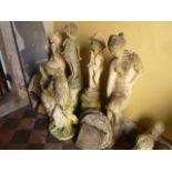 A weathered cast composition stone garden ornament in the form of a classical female figure, further