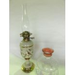 A 19th century oil burning lamp with opaque glass sectional fount with pale beige ground detailed