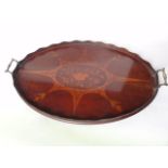 An Edwardian mahogany tray of oval form with extensive foliate and other central inlay contained