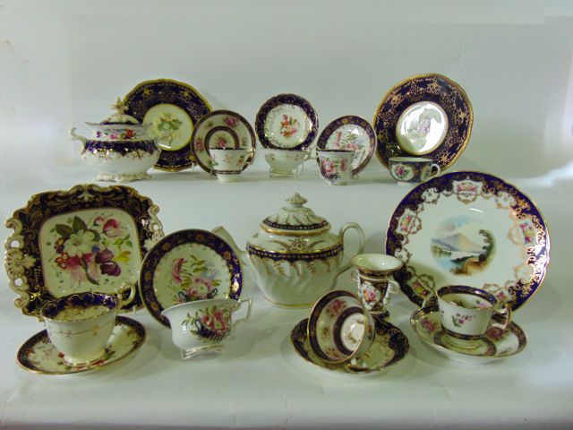 A collection of 19th century tea wares with painted floral decoration within blue and gilt borders