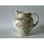 An ivory ground Royal Worcester jug with painted and gilded blossom and other floral sprays, with