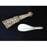 A 19th century ivory spoon with geometric detail and a 19th century ivory horn with geometric