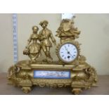 A 19th century spelter mantle clock in a romantic theme, the drum movement set within a circular