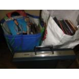 A quantity of unsorted vinyl 45 rpm singles and a further selection of vinyl albums, approximately