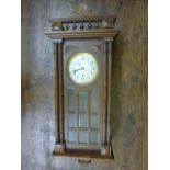 An early 20th century continental wall clock in a walnut case with anodised dial, front case with