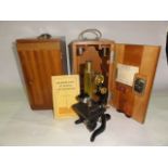 A vintage brass and iron mounted microscope stamped E Leitz Wetzlar No 134493 set within an