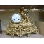 A 19th century gilded mantle clock of romantic form showing a young child viewing a mirror set on