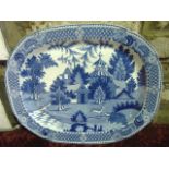 A large early 19th century blue and white meat plate of oval form with chinoiserie style landscape