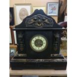 A substantial Victorian black slate and marble mantle clock with applied brass panel and eight day