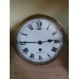 A Smiths bulkhead clock in a brass work and steel case and with enamelled dial and eight day