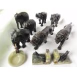 A selection of antique ebony figures of animals to include two pairs of elephants with raised trunks