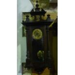 A late 19th century continental wall clock, the walnut case with split spindle mouldings, with