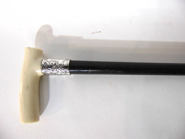 An antique ebonised walking cane set beneath a worked ivory handle and silver collar hallmarked - Image 2 of 2