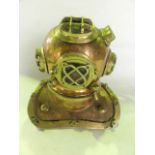 A model of a 19th century diver's standard helmet with extensive mounts and applied detail in brass,