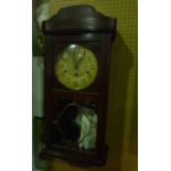 A 1920s German wall clock with anodised dial, the mahogany case with plate glass front enclosing a