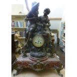 A 19th century continental mantle clock in spelter, the small eight day striking movement surmounted