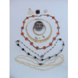 An Art Deco style black and white bead necklace; three bangles; a tri-gold coloured metal fringe