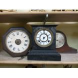 A Victorian cast iron mantle clock, a Napoleon top hat mantle clock in an oak case and a postmans