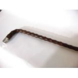 A thorn wood walking cane with crooked handle terminating in an applied silver cap, hallmarked