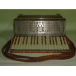 A vintage Casale Verona piano accordion with mottled pink casing,  white buttons and gold bellows,