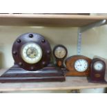 Four timber cased clocks including an example with simulated propellor hub case work, an inlaid