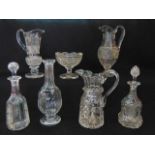 A good quality 19th century clear cut glass ewer with extensive hob and slice cut detail raised on a
