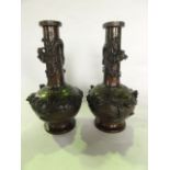 A pair of Chinese cast bronze vases of bulbous form with drawn cylindrical necks with extensive