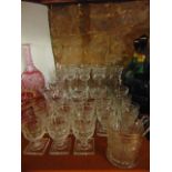 A good selection of clear drinking glasses to include three large and one small matching heavy