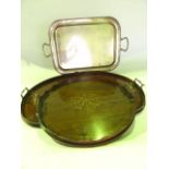 An Edwardian tray of circular form, principally in mahogany with raised shaped sides and brass