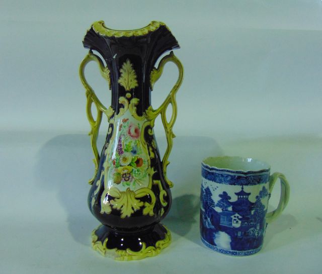 A large 18th century tankard with blue and white painted chinoiserie decoration with double reeded