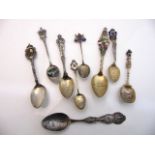 A miscellaneous collection of eight sterling silver souvenir spoons, some enamelled and in gilt,