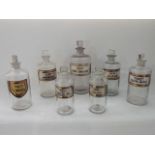 Seven various 19th century clear glass chemist's flasks/bottles of cylindrical form, each with