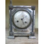 An Edwardian silver plated mantle clock, the case with applied detail and with engine turned dial