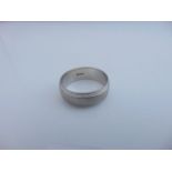 A gentleman's platinum ring, stamped 950, the plain polished shank applied with a central brushed