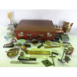 A vintage stitched tan leather suitcase containing a miscellaneous collection to include a miniature