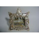 A Eastern shrine, principally in cut mother-of-pearl, the squared and glazed front revealing an