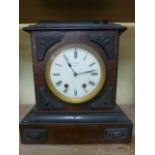 A late 19th century walnut mantle clock, the case with applied detail enclosing a two train movement