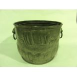 A 19th century hammered brass coal cauldron of cylindrical form raised on an inverted cylindrical