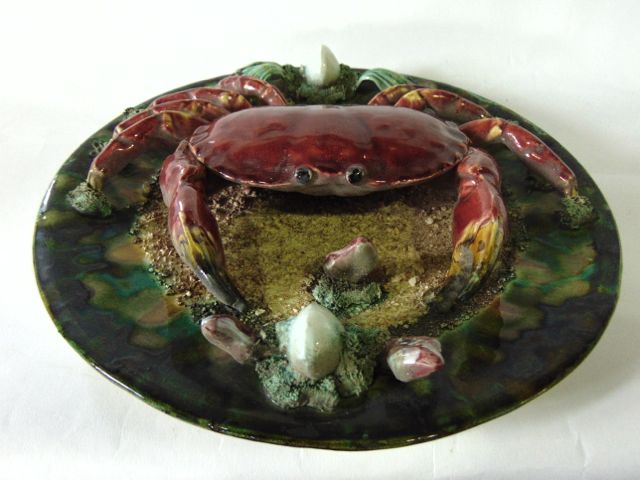 A Portuguese Palissy style charger with applied model of a crab, with further encrusted shell and