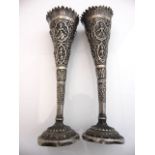 A pair of white metal post vases, each with Hindu God relief details, 20cm high (2)