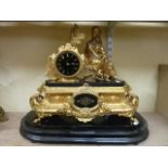 A substantial Victorian gilded mantle clock with marble plinth and dial surmounted by a female
