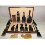 A vintage timber box containing an assortment of hardwood combs with carved handles, etc