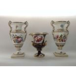 A pair of 19th century two handled vases with painted floral sprigs and sprays and scrolling